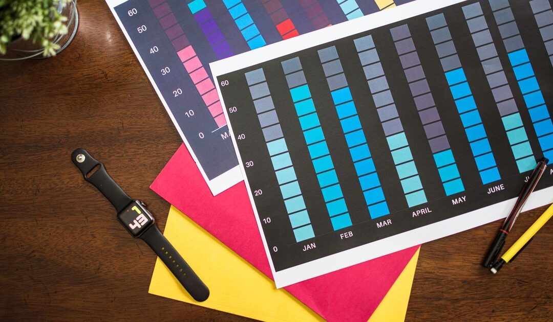 A wall calendar and a paper project plan on a desk, representing a multi-month audit schedule