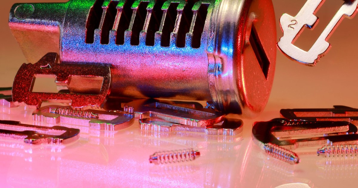 A ring of keys beside a monitor showing a list of user accounts, representing periodic review of system access